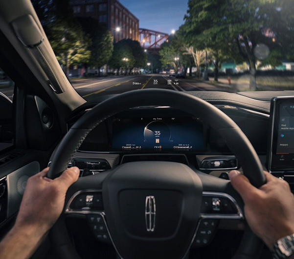 Hands on steering wheel with head-up display