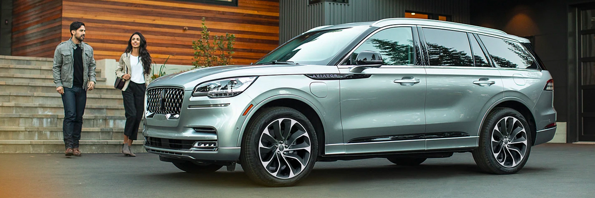 Lincoln Aviator parked in driveway of modern home.