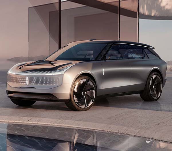 Exterior shot of a EV Lincoln Star Concept parked in front of a house.