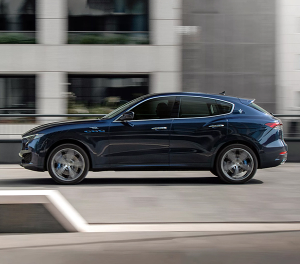 The 2023 Maserati Levante from the side driving through a city street