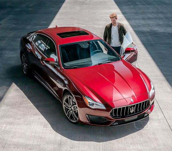 The 2023 Maserati Quattroporte parked with a person opening the front door