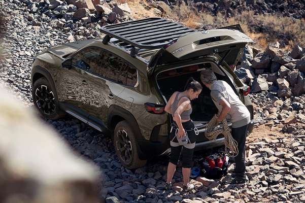 2023 Mazda CX-50 parked with couple unpacking the back