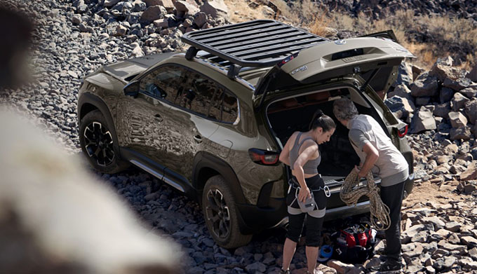 2023 Mazda CX-50 parked with couple unpacking the back