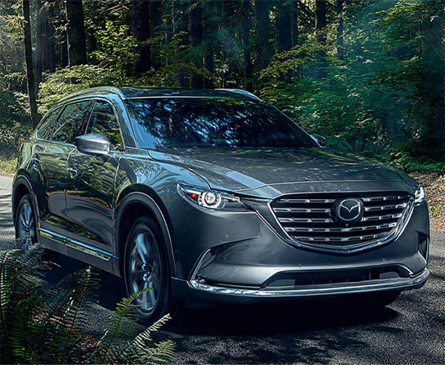 2023 MAZDA CX-9 driving through a forest