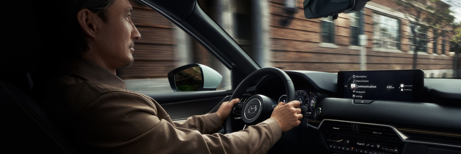 man driving Mazda vehicle