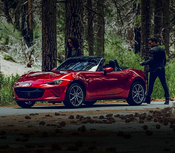 Man getting in a 2023 Mazda MX-5 Miata