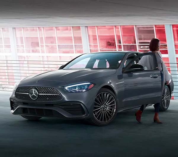 Person exiting their 2023 Mercedes-Benz C-Class in a parking garage