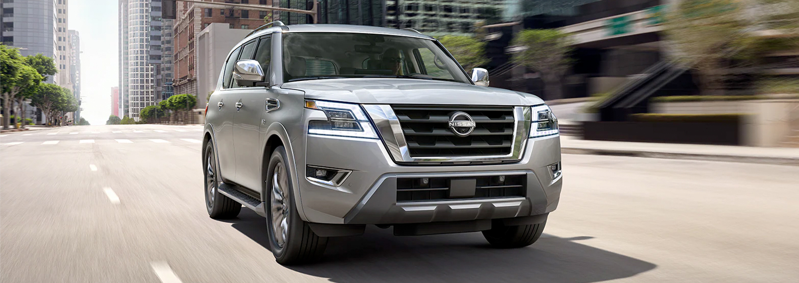 Front view of 2023 Nissan Armada driving down road.