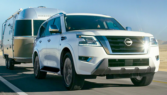 2023 Nissan Armada towing an airstream on a desert highway.