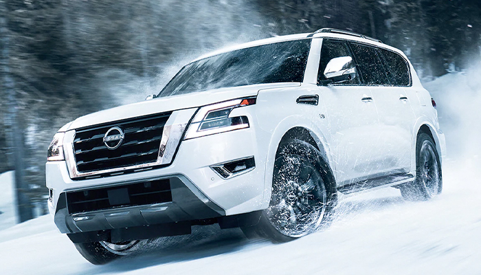 2023 Nissan Armada driving off-road in a snow-covered forest