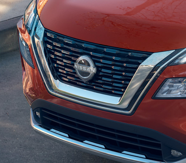 2023 Nissan Rogue in scarlet ember showing v-motion grille.