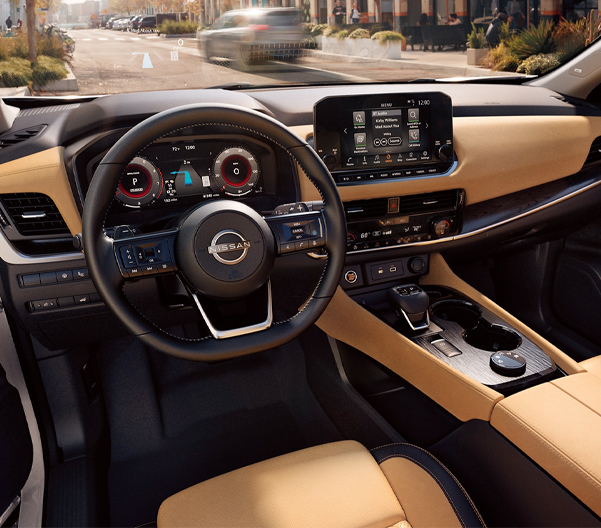 2023 Nissan Rogue view of dash showing head up display, gauges, and touch-screen.