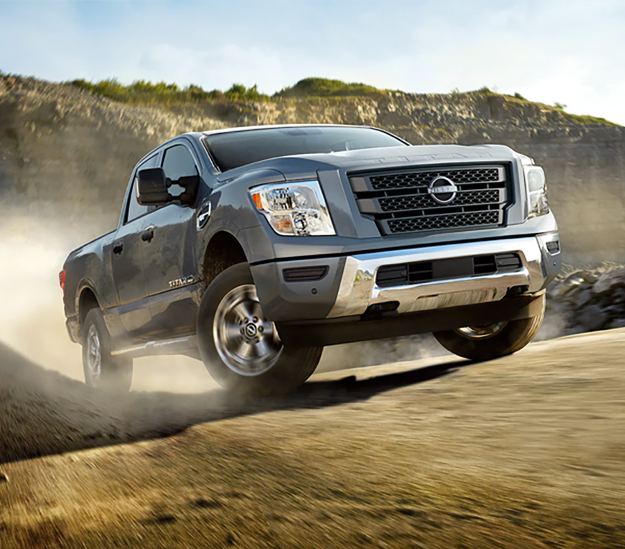 2023 Nissan TITAN XD crew cab going up a dirt road.