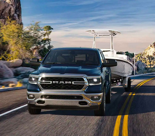 2023 RAM 1500 racing along a coastal road