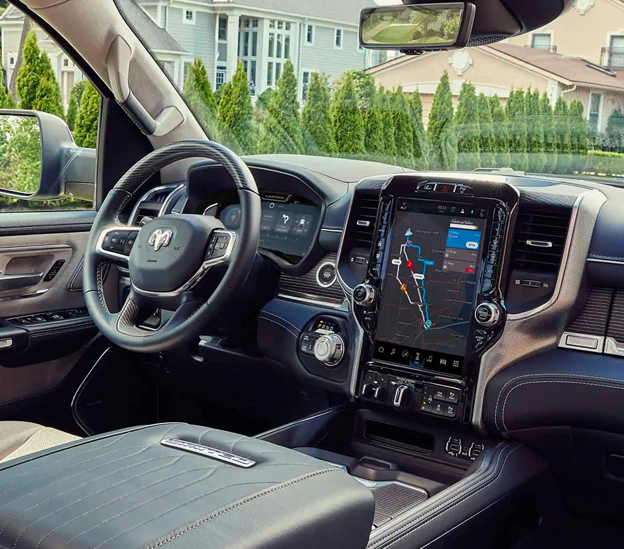 The interior of the 2023 RAM 1500 with the large Uconnect touchscreen displaying a navigation map.
