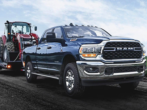 2023 RAM 2500 towing a tractor
