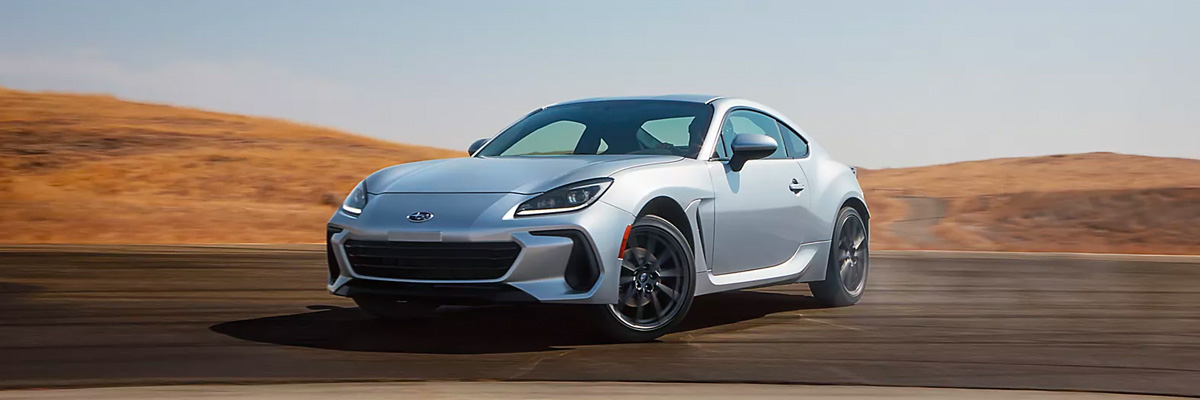 2022 Subaru BRZ Limited shown in Ice Silver Metallic rounding a curve on a highway.
