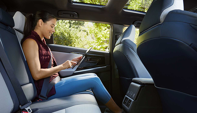 A woman in the spacious back seat of a 2023 Solterra.