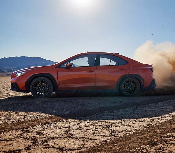 2023 Subaru WRX racing along a desert road
