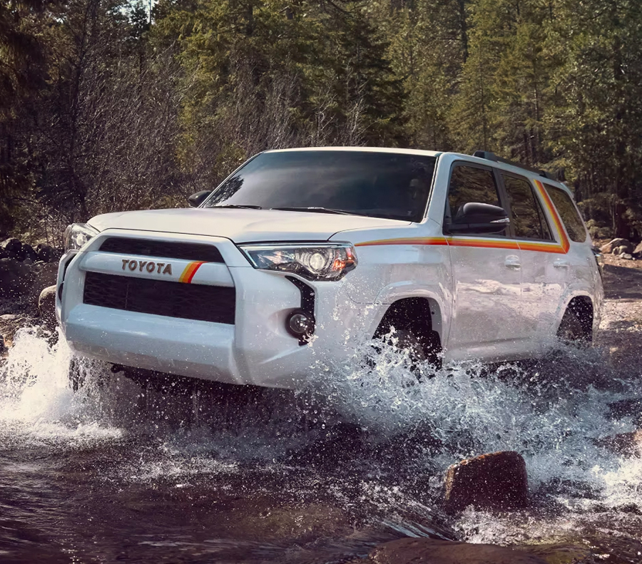 2023 Toyota 4Runner driving across a creek