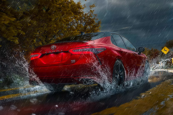 2023 Toyota Camry rear view driving through rain