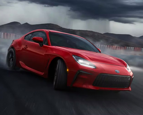 GR86 Premium shown in Track bRED. Prototype shown using visual effects and depicting Vehicle Stability Control (VSC) off while driving on a closed course. Professional driver. Do not attempt.