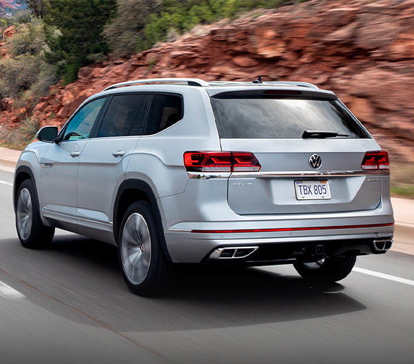 Atlas in Pyrite Silver Metallic seen from the rear driving on a mountain road.