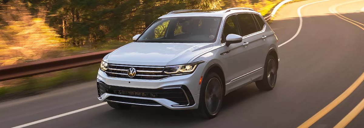 2023 VW Tiguan driving down a scenic road