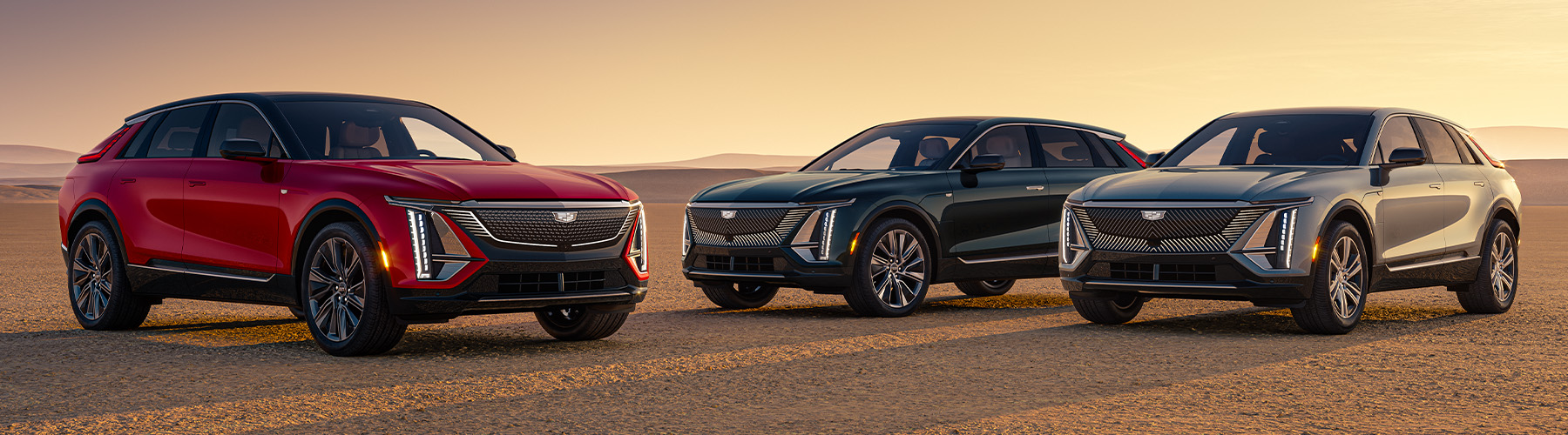 Cadillac 2024 LYRIQ Pack Shot; L to R: LRYIQ Sport in Radiant Red Tintcoat, LYRIQ Luxury in Emerald Lake Metallic, and LYRIQ Tech in Argent Silver
