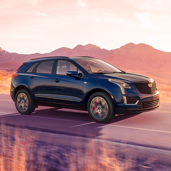 Front 3/4 Cadillac XT5 driving on road at desert