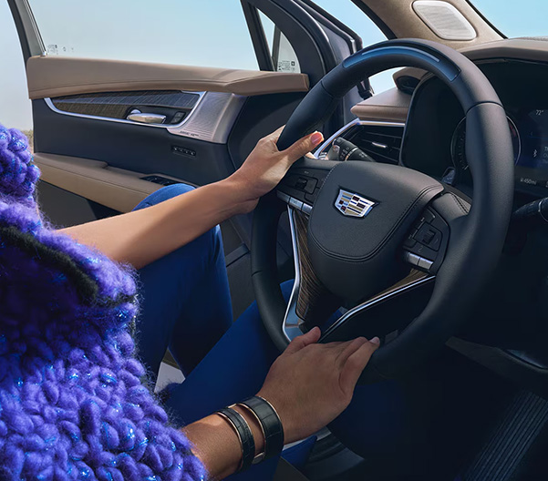 woman driving a cadillac