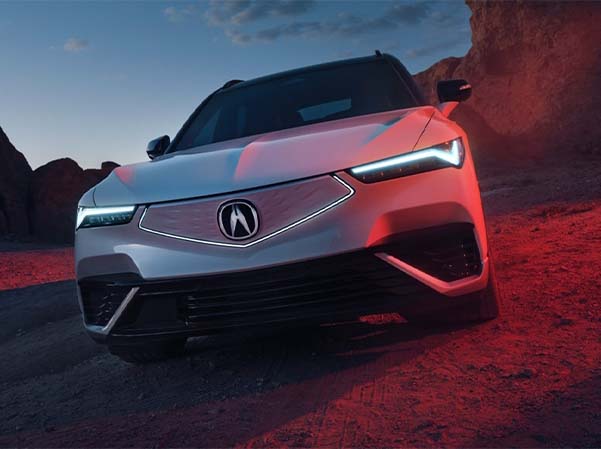 2024 Acura ZDX parked in a dirt lot on a desert road