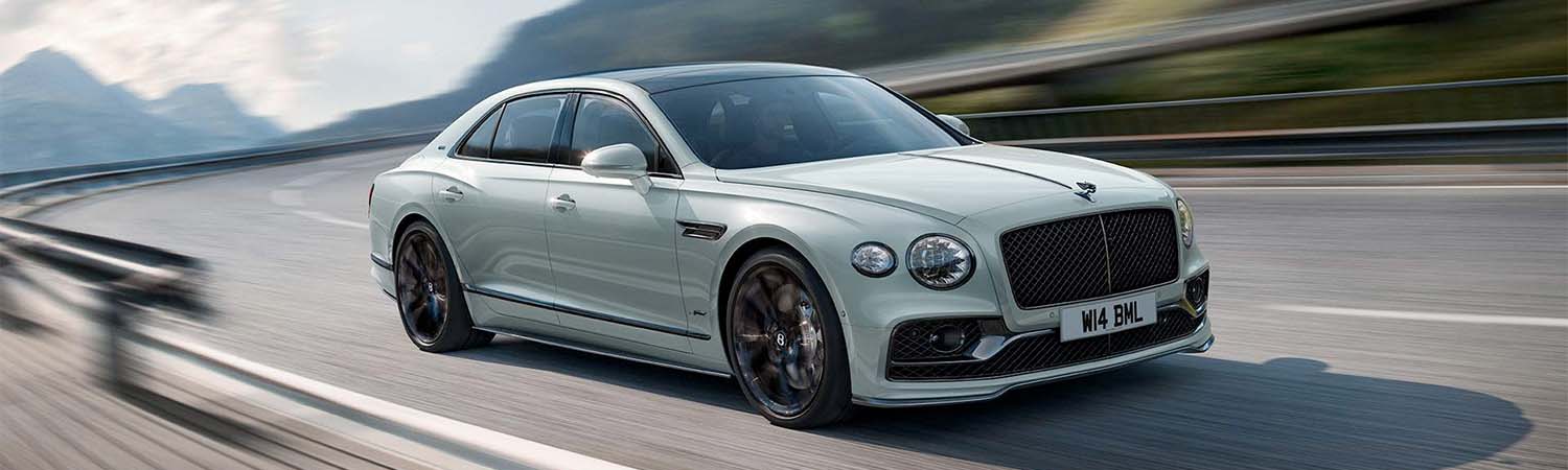 The 2024 Bentley Flying Spur speeding down a curved road