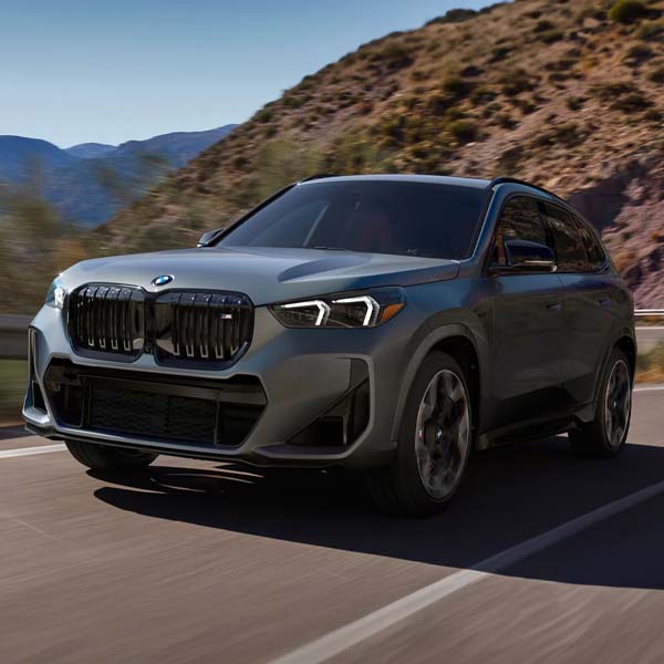 2024 BMW i4 M50 driving on a mountain highway