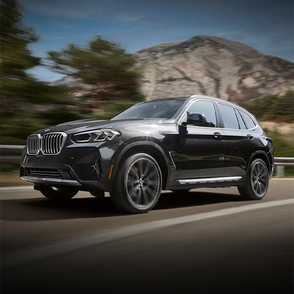 2024 BMW X3 driving down a highway