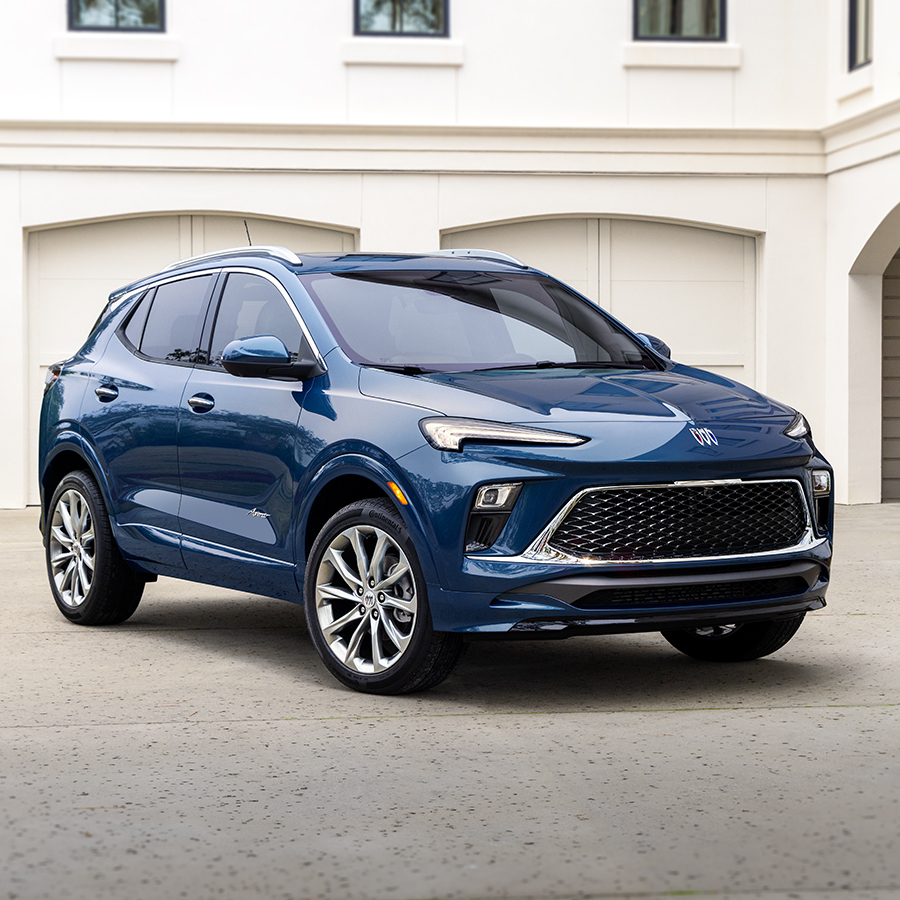 The 2024 Buick Encore GX Avenir Parked in Front of a Luxurious Home