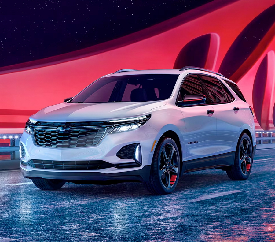 2023 Equinox EV Front 3/4 of Drivers Side on City Street at Night