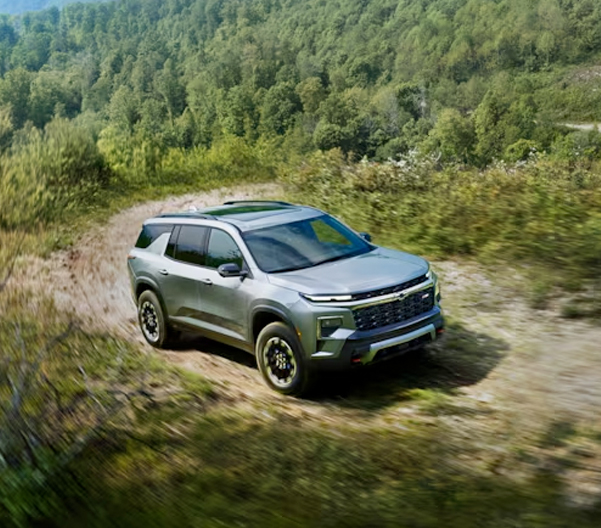 2024 Chevy Traverse Mid-Size SUV Driving on a Dirt Road