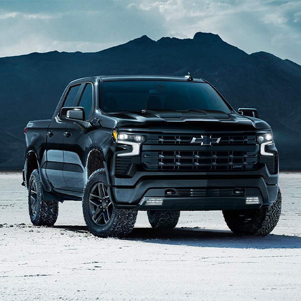 The 2024 Silverado Parked Near the Mountains on a Snow Covered Ground