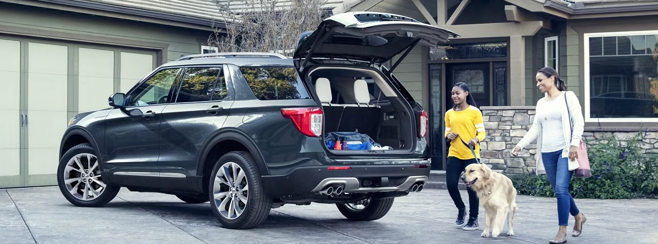 Family and dog walking towards their Ford SUV