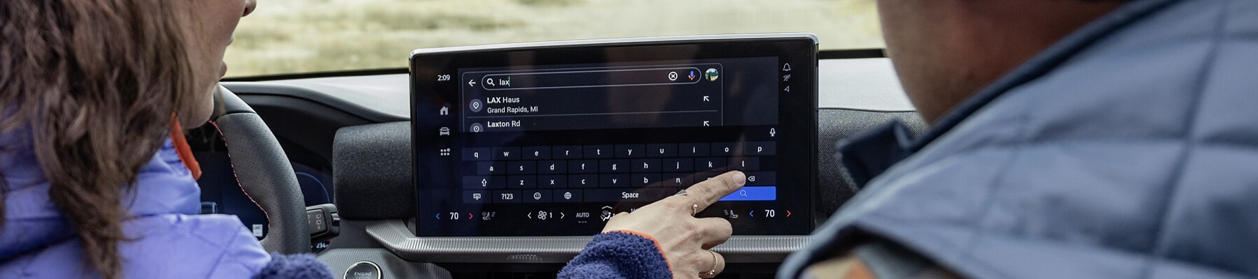couple using navigation in ford vehicle