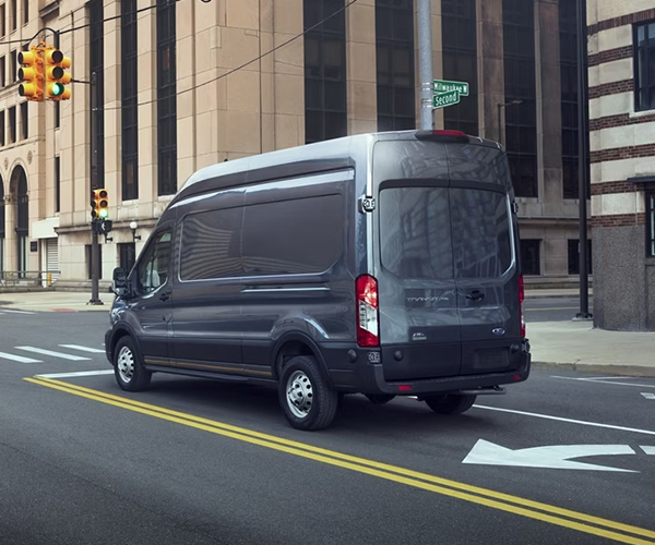A 2024 Ford Transit® van being driven down a city street