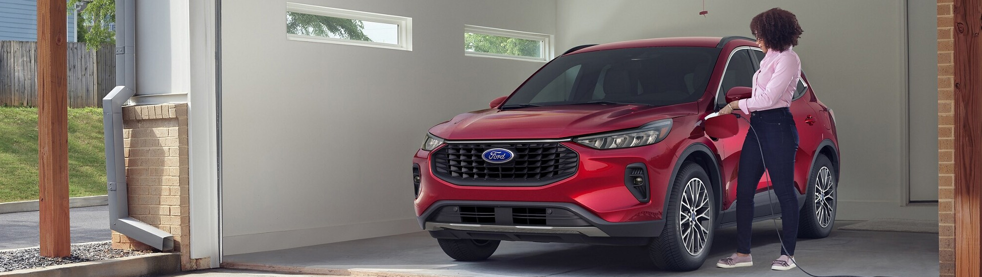Woman charging a plug-in hybrid 2025 Ford Escape® SUV