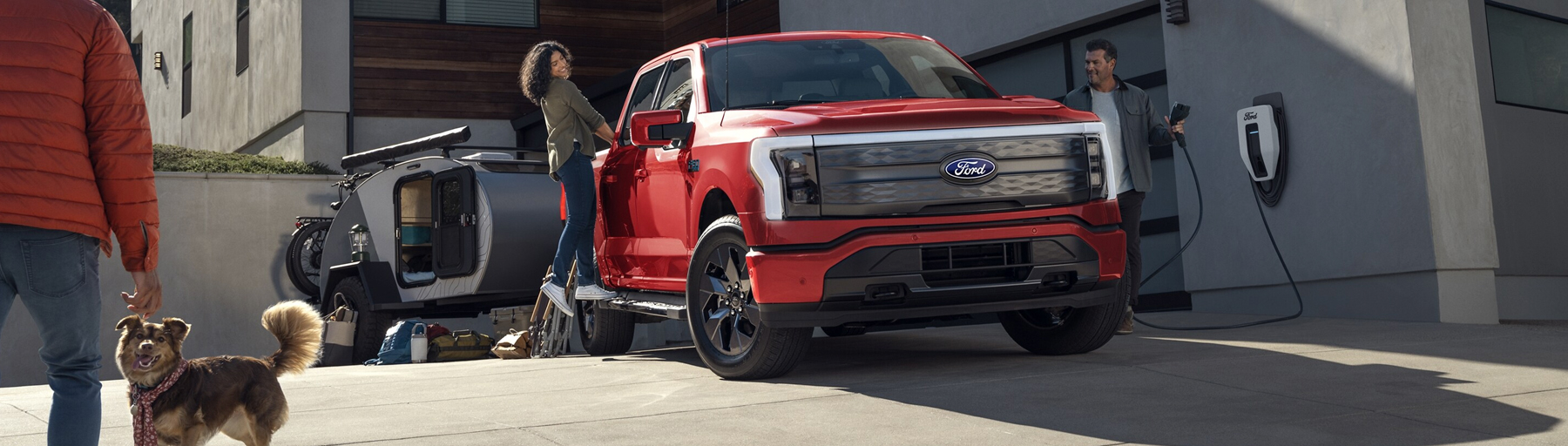 A family charging their Ford F-150 Lightning® at home before a trip