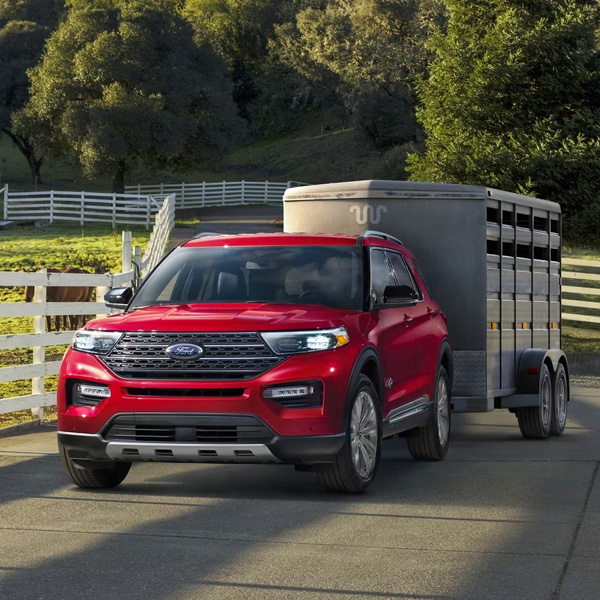 2024 Ford ExplorerÂ® King RanchÂ® model parked near a stable with a horse trailer attached