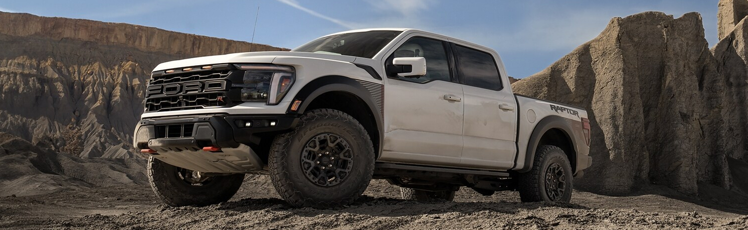 2024 Ford F-150® Raptor R™ in Oxford White parked on a rocky path in the mountains