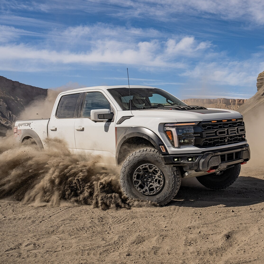2024 Ford F-150® Raptor R™ truck being driven in the desert kicking up clouds of sand