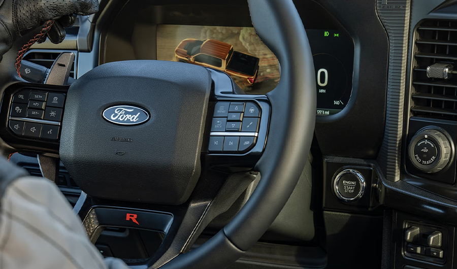 Image of the steering wheel and center stack and 12-inch display screen on a 2024 Ford F-150® Raptor R™ truck