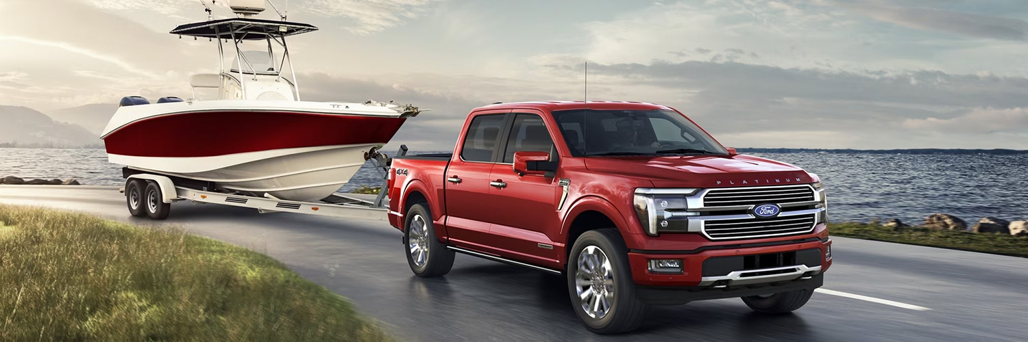 Red Ford F-150 towing a boat