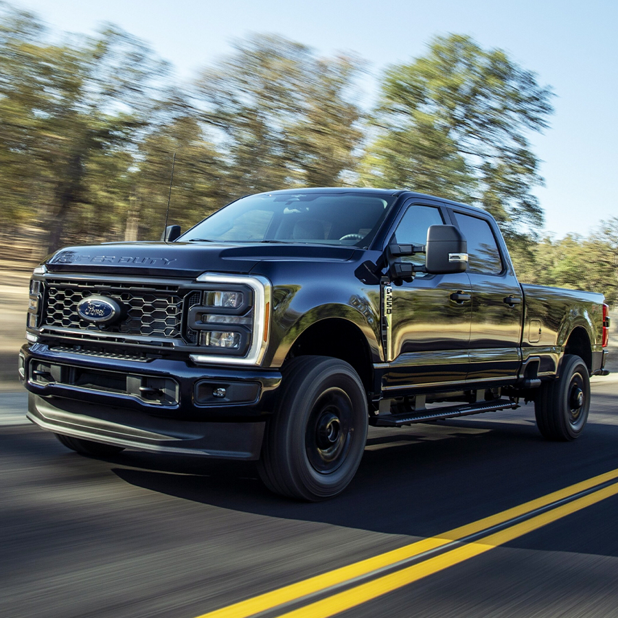Front view of black Ford F250 Super Duty driving on road